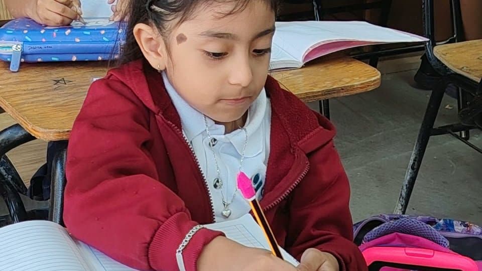 Emily trabajando en su cuaderno en el Colegio San Isidro